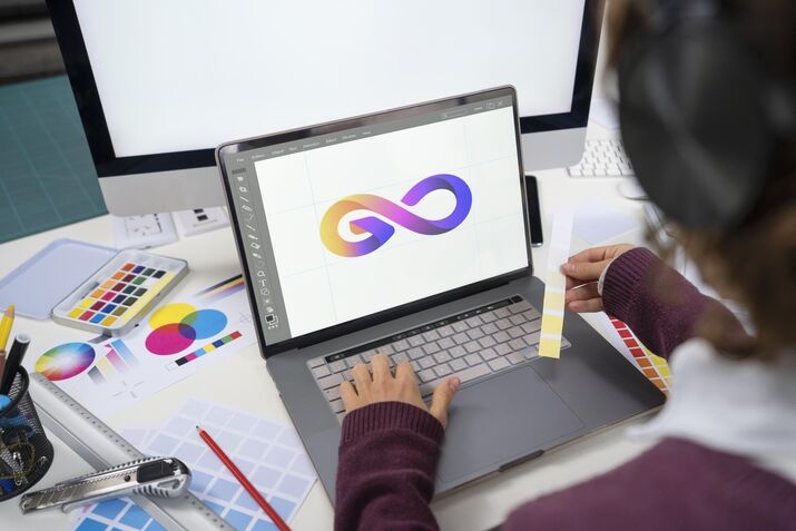 Graphic designer creating a colorful logo using AI-powered branding and design software
